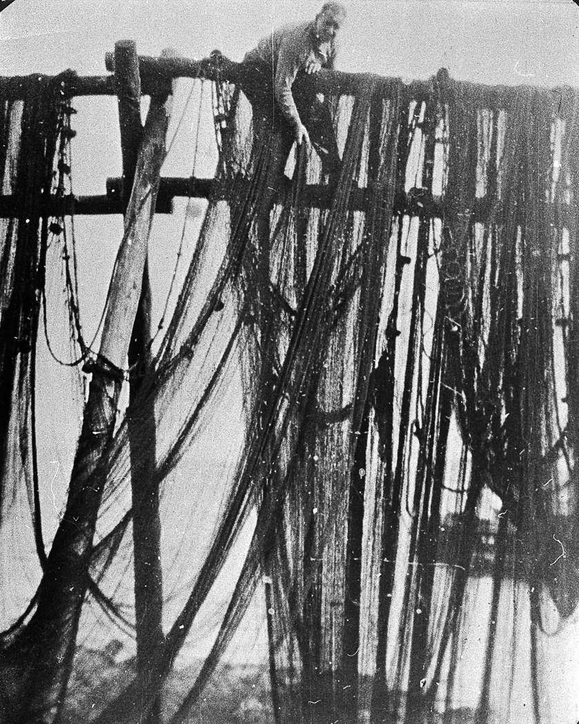 Donald McIntosh with nets on net poles, Carradale, c.1930.
