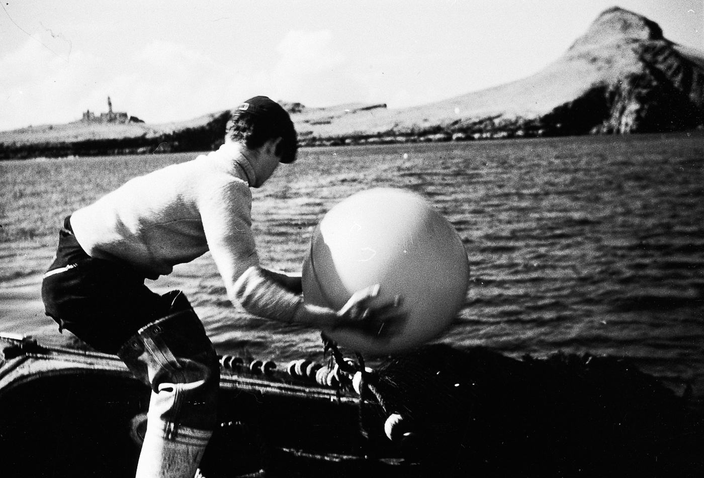 Fisherman shooting a ringnet by throwing over a centre float, possibly onboard 'Margaret Ann II', OB198.
