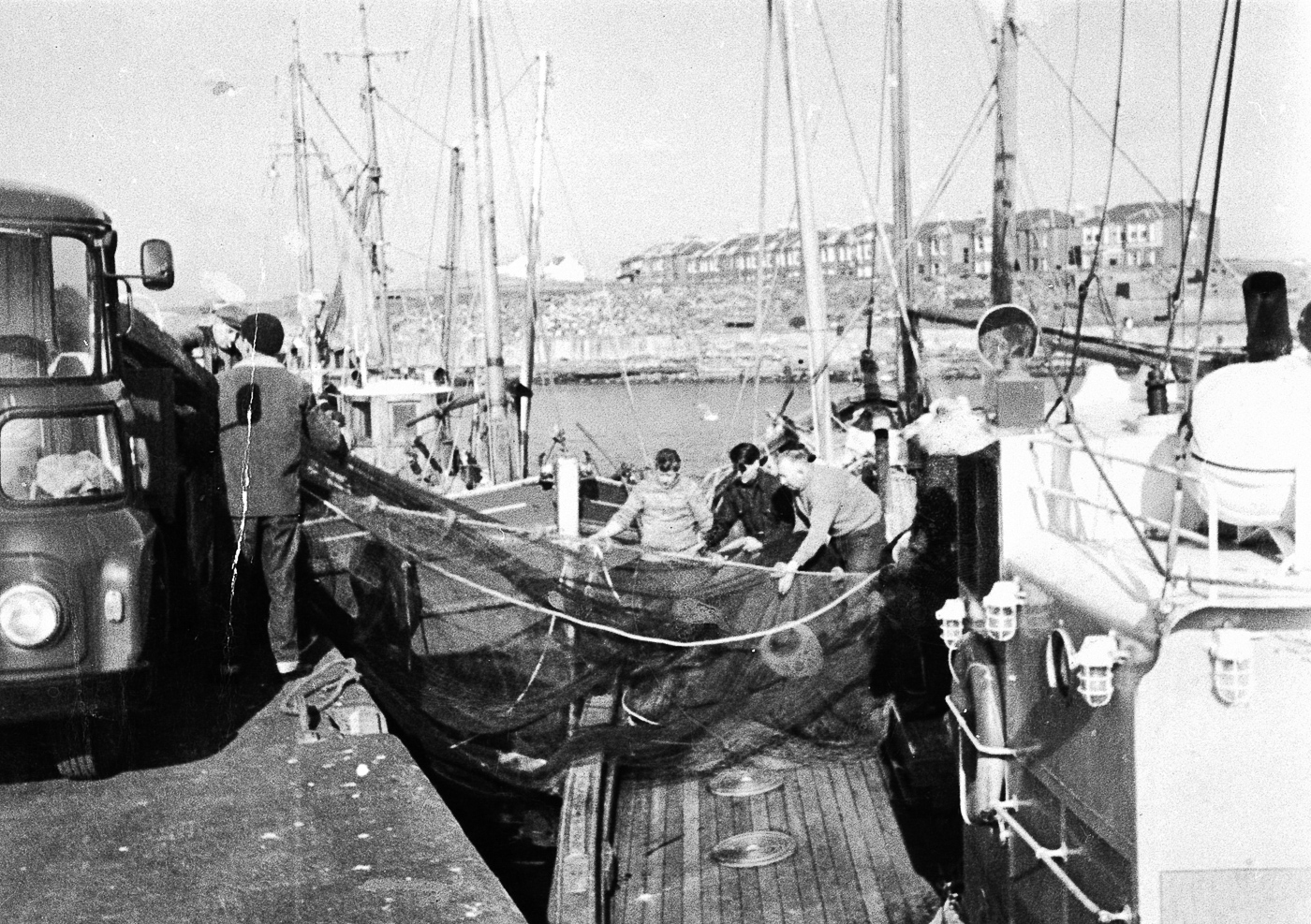 Group of men taking a ringnet onboard Aliped IX, Girvan