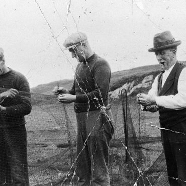 Crew of 'Theresa' mending a ringnet, Carradale. L-R: Donald Mitchell, John Galbraith, James Conley, and Lachlan Patterson.