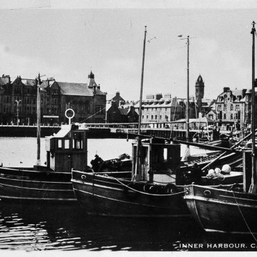 Postcard entitled 'Inner Harbour, Campbeltown' showing ringnetters 'Acadia', CN56, 'Harvest Queen', CN167, and 'Regina Maris', CN118. 'Acacia', CN56, was built in Portavogie, 1949. 'Harvest Queen', CN167, was built in Fairlie in 1949 then later sold to Skye in 1983.