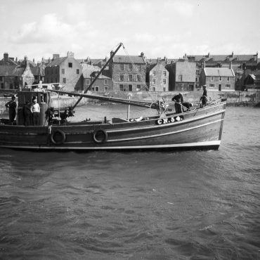 'Almanzora' CN54, in harbour, St Monans, 1949. 'Alamanzora', CN54, was bulit by J. N. Miller boatbuilders, St Monans, for the Robertson brothers who lived on the west coast. She was 53ft long and weighed 23 tons. She later became 'Mairead', TT104, then 'Sancta Virgo', CY254. She stopped fishing in 1979 then was later sold abroad.