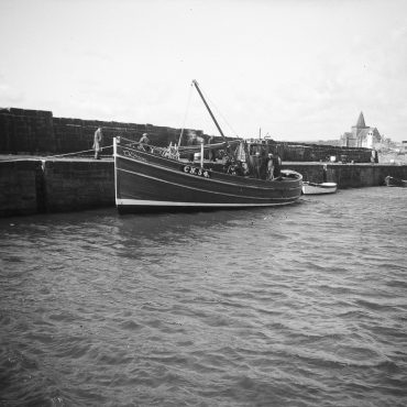'Almanzora' CN54, in harbour, St Monans, 1949. 'Almanzora', CN54, was bulit by J. N. Miller boatbuilders, St Monans, for the Robertson brothers who lived on the west coast. She was 53ft long and weighed 23 tons. She later became 'Mairead', TT104, then 'Sancta Virgo', CY254. She stopped fishing in 1979 then was later sold abroad.